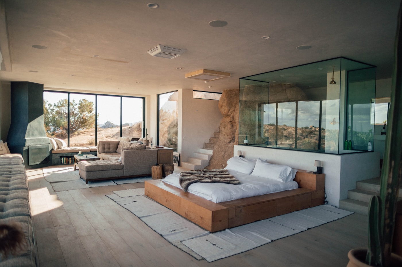 Elegant hotel suite with a large bed and ocean view