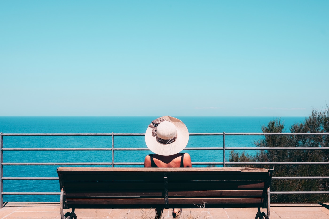 Traveler looking over a coastal city from a scenic overlook